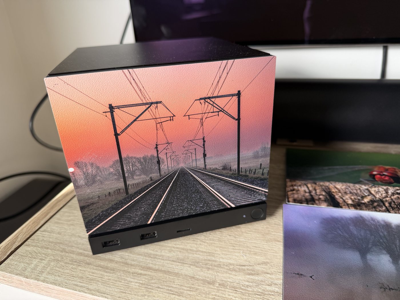 Railway Sunrise panel on the reference machine, with a stack of fresh test prints beside it